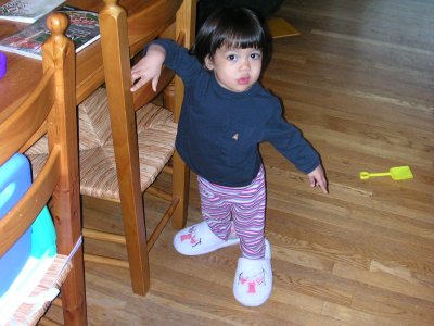 Mia wearing Mom's slippers