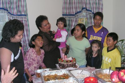 Mia, held by Tita Vicky, with extended family