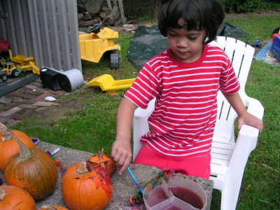 Mia painting pumpkins